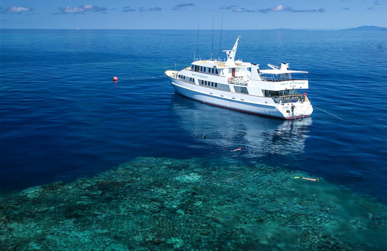 image of scuba diving liveaboard vessel Spirit of Freedom over blue water australia