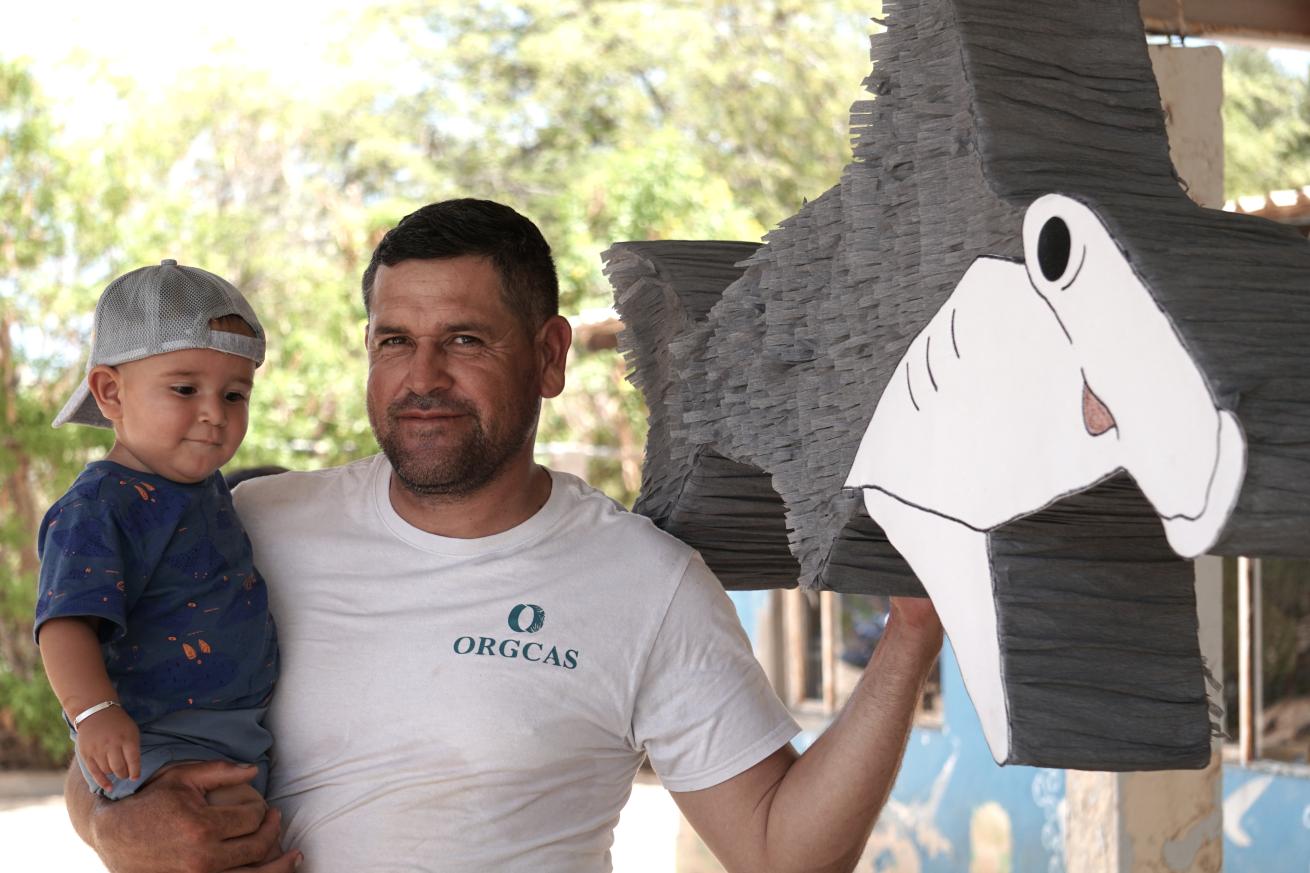 Former shark fisherman with his son at an educational event organized by ORGCAS