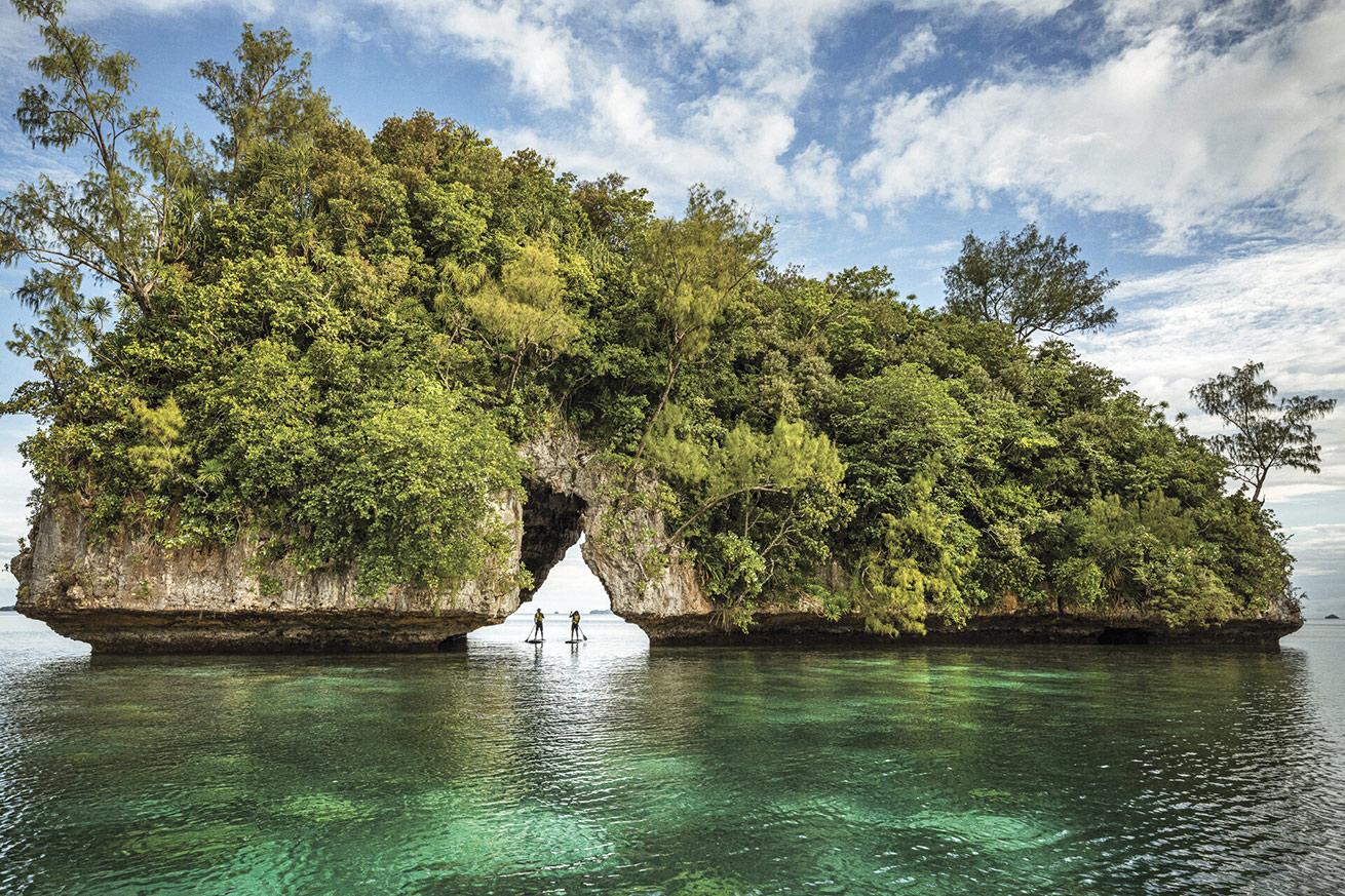 Paddleboarders check out the unique Rock Islands topography.