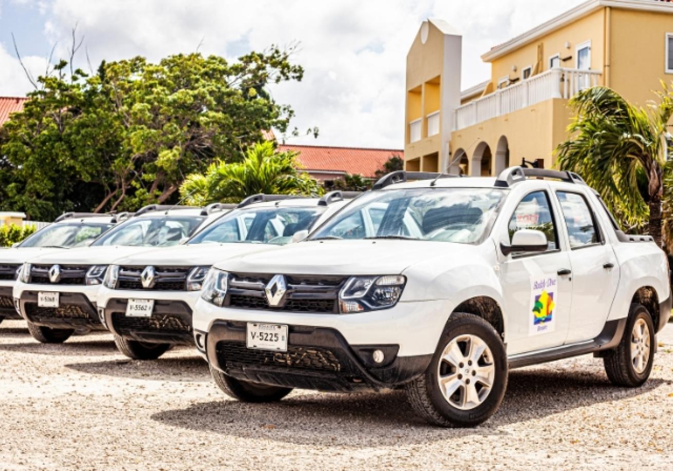 A row of white cars parked in a row