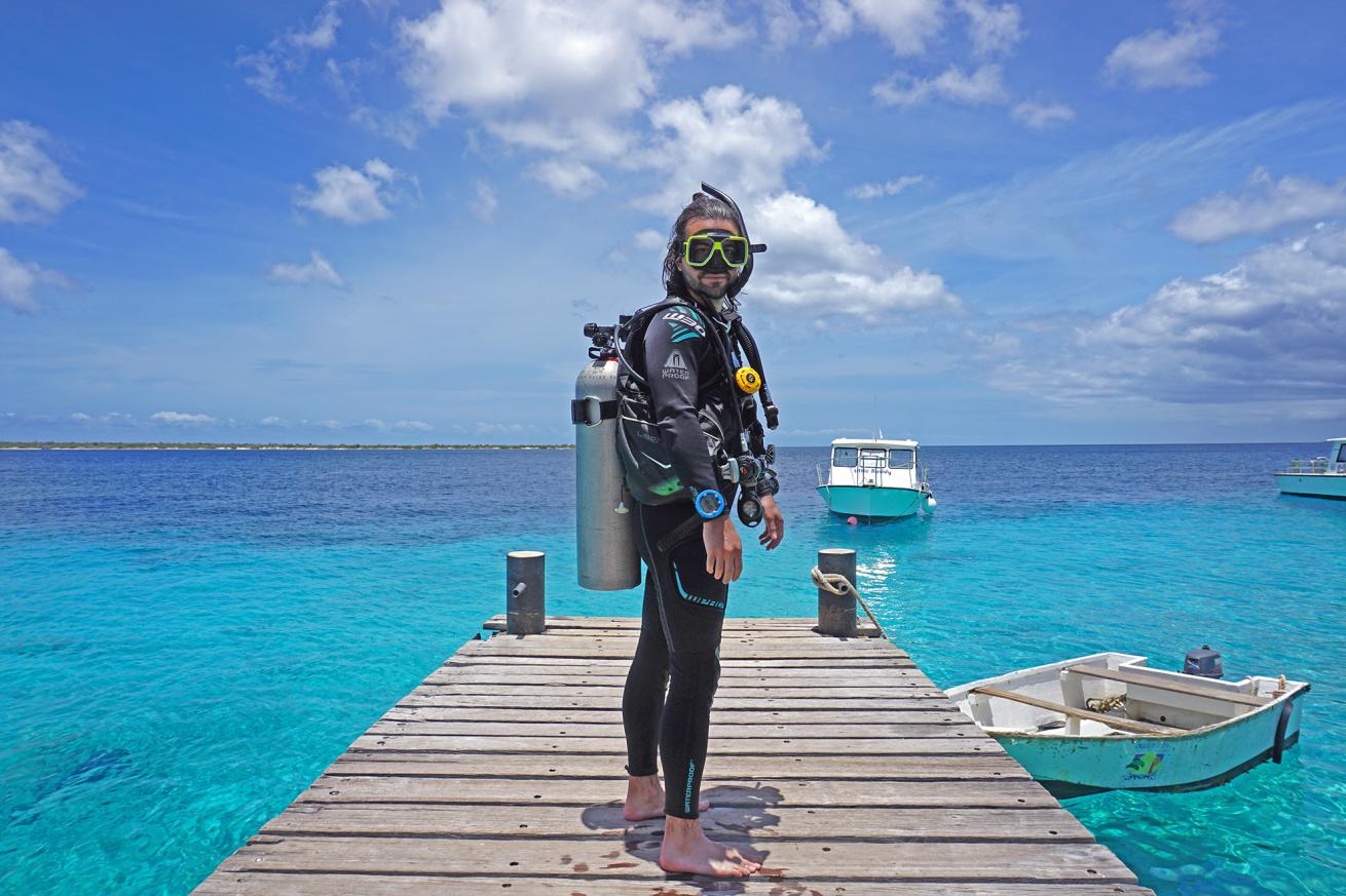 Journalist James Barrett kits up for for his open water training in Bonaire at Buddy Dive.